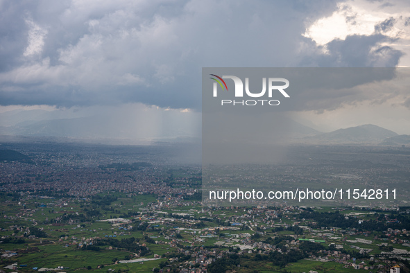 Rainfall over Kathmandu Valley as seen from Nagarkot in Kathmandu, Nepal, on October 5, 2023. 