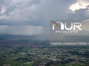 Rainfall over Kathmandu Valley as seen from Nagarkot in Kathmandu, Nepal, on October 5, 2023. (