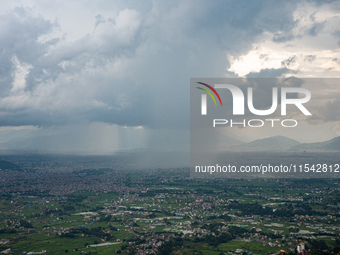 Rainfall over Kathmandu Valley as seen from Nagarkot in Kathmandu, Nepal, on October 5, 2023. (