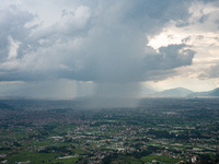 Rainfall over Kathmandu Valley as seen from Nagarkot in Kathmandu, Nepal, on October 5, 2023. (