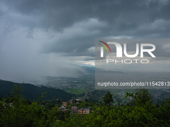 Rainfall over Kathmandu Valley as seen from Nagarkot in Kathmandu, Nepal, on October 5, 2023. (