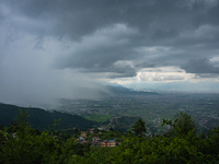 Rainfall over Kathmandu Valley as seen from Nagarkot in Kathmandu, Nepal, on October 5, 2023. (