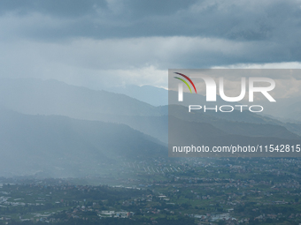 Rainfall over Kathmandu Valley as seen from Nagarkot in Kathmandu, Nepal, on October 5, 2023. (