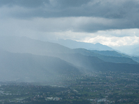 Rainfall over Kathmandu Valley as seen from Nagarkot in Kathmandu, Nepal, on October 5, 2023. (