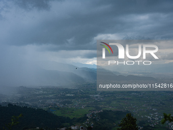 Rainfall over Kathmandu Valley as seen from Nagarkot in Kathmandu, Nepal, on October 5, 2023. (