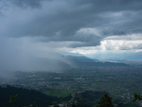 Rainfall over Kathmandu Valley as seen from Nagarkot in Kathmandu, Nepal, on October 5, 2023. (