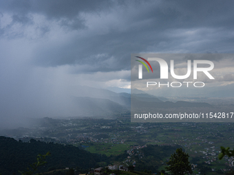 Rainfall over Kathmandu Valley as seen from Nagarkot in Kathmandu, Nepal, on October 5, 2023. (