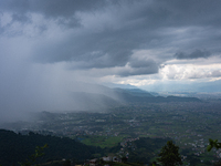 Rainfall over Kathmandu Valley as seen from Nagarkot in Kathmandu, Nepal, on October 5, 2023. (