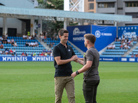 In Andorra La Vella, Andorra, on August 31, 2024, Ferran Costa, coach of FC Andorra, and Albert Sanchez, coach of FC Barcelona Atletic, are...