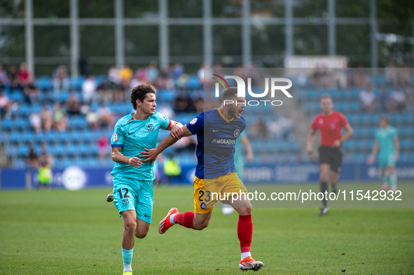 Diego Alende of FC Andorra and Juan Piera of FC Barcelona Atletic are in action during the Primera RFEF 2024-2025 match between FC Andorra a...