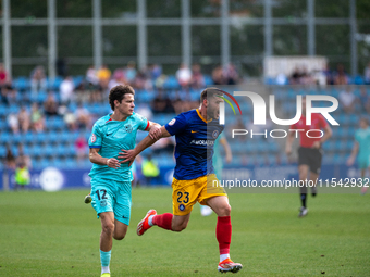 Diego Alende of FC Andorra and Juan Piera of FC Barcelona Atletic are in action during the Primera RFEF 2024-2025 match between FC Andorra a...