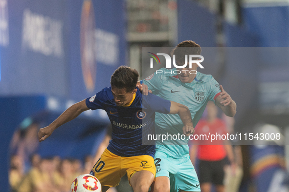 In Andorra La Vella, Andorra, on August 31, 2024, Alvaro Martin of FC Andorra and Trilli of FC Barcelona Atletic are in action during the Pr...