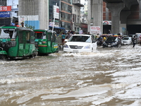 Vehicles and rickshaws attempt to navigate the waterlogged streets of Dhaka with passengers on September 3, 2024, after heavy monsoon rains...