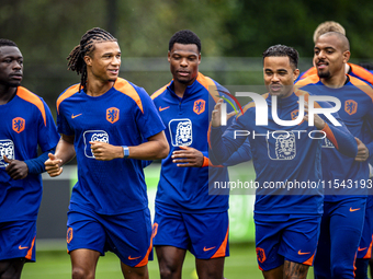 Netherlands players Brian Brobbey, Nathan Ake, Denzel Dumfries, and Justin Kluivert participate in training and a press conference at the KN...