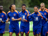 Netherlands players Brian Brobbey, Nathan Ake, Denzel Dumfries, and Justin Kluivert participate in training and a press conference at the KN...