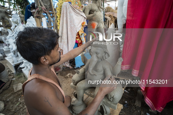 Artisans work on idols of the elephant-headed Hindu deity Ganesha at a workshop ahead of the Ganesh Chaturthi festival in Guwahati, Assam, I...