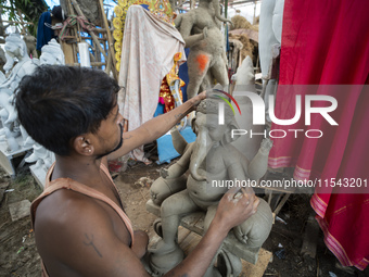 Artisans work on idols of the elephant-headed Hindu deity Ganesha at a workshop ahead of the Ganesh Chaturthi festival in Guwahati, Assam, I...