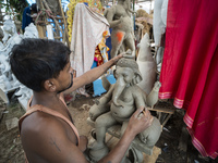 Artisans work on idols of the elephant-headed Hindu deity Ganesha at a workshop ahead of the Ganesh Chaturthi festival in Guwahati, Assam, I...