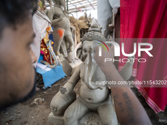 Artisans work on idols of the elephant-headed Hindu deity Ganesha at a workshop ahead of the Ganesh Chaturthi festival in Guwahati, Assam, I...