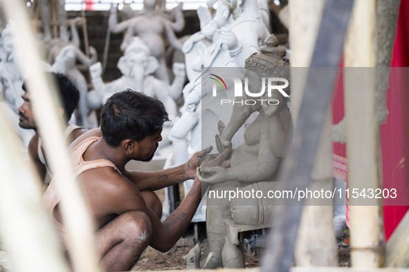 Artisans work on idols of the elephant-headed Hindu deity Ganesha at a workshop ahead of the Ganesh Chaturthi festival in Guwahati, Assam, I...