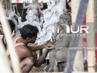 Artisans work on idols of the elephant-headed Hindu deity Ganesha at a workshop ahead of the Ganesh Chaturthi festival in Guwahati, Assam, I...