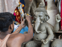 Artisans work on idols of the elephant-headed Hindu deity Ganesha at a workshop ahead of the Ganesh Chaturthi festival in Guwahati, Assam, I...