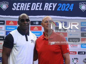 Roberto Kelly, manager of Sultanes de Monterrey, and Lorenzo Bundy, manager of Diablos Rojos, pose for photos after the press conference for...