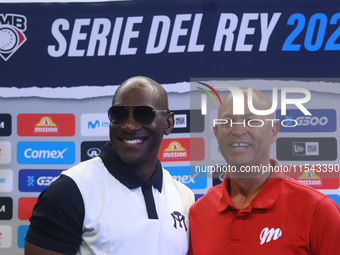 Roberto Kelly, manager of Sultanes de Monterrey, and Lorenzo Bundy, manager of Diablos Rojos, pose for photos after the press conference for...