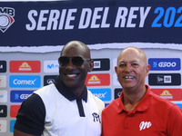 Roberto Kelly, manager of Sultanes de Monterrey, and Lorenzo Bundy, manager of Diablos Rojos, pose for photos after the press conference for...