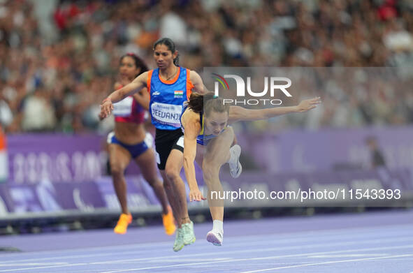 Yuliia Shuliar of Ukraine celebrates winning gold in Women's 400m - T20 Final during the Paris 2024 Paralympic Games at Stade de France on S...