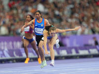 Yuliia Shuliar of Ukraine celebrates winning gold in Women's 400m - T20 Final during the Paris 2024 Paralympic Games at Stade de France on S...