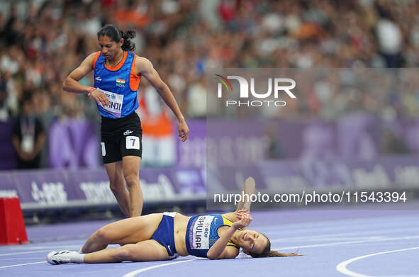 Yuliia Shuliar of Ukraine celebrates winning gold in Women's 400m - T20 Final during the Paris 2024 Paralympic Games at Stade de France on S...