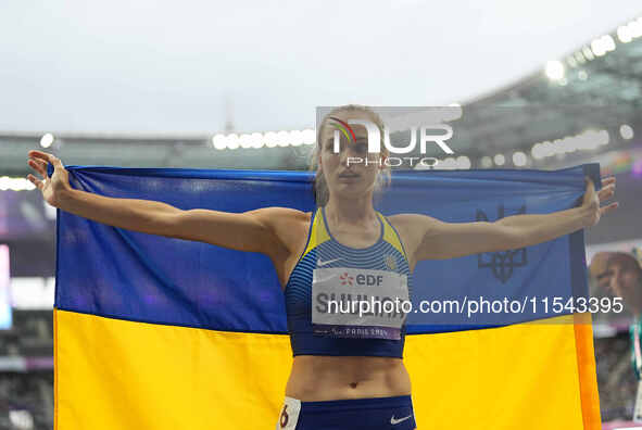 Yuliia Shuliar of Ukraine celebrates winning gold in Women's 400m - T20 Final during the Paris 2024 Paralympic Games at Stade de France on S...