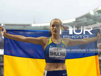 Yuliia Shuliar of Ukraine celebrates winning gold in Women's 400m - T20 Final during the Paris 2024 Paralympic Games at Stade de France on S...