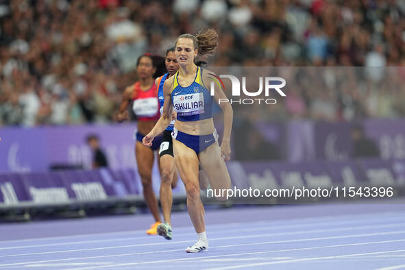 Yuliia Shuliar of Ukraine celebrates winning gold in Women's 400m - T20 Final during the Paris 2024 Paralympic Games at Stade de France on S...