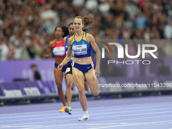 Yuliia Shuliar of Ukraine celebrates winning gold in Women's 400m - T20 Final during the Paris 2024 Paralympic Games at Stade de France on S...