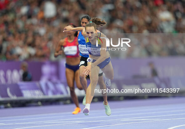 Yuliia Shuliar of Ukraine celebrates winning gold in Women's 400m - T20 Final during the Paris 2024 Paralympic Games at Stade de France on S...