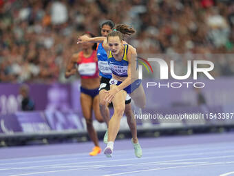 Yuliia Shuliar of Ukraine celebrates winning gold in Women's 400m - T20 Final during the Paris 2024 Paralympic Games at Stade de France on S...