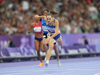 Yuliia Shuliar of Ukraine celebrates winning gold in Women's 400m - T20 Final during the Paris 2024 Paralympic Games at Stade de France on S...