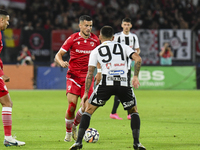 Astrit Selmani is in action during Universitatea Cluj vs. Dinamo Bucuresti at Cluj Arena in Cluj-Napoca, Romania, on September 2, 2024 (