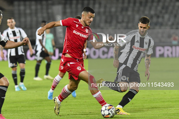 Astrit Selmani and Ovidiu Popescu are in action during Universitatea Cluj vs. Dinamo Bucuresti at Cluj Arena in Cluj-Napoca, Romania, on Sep...