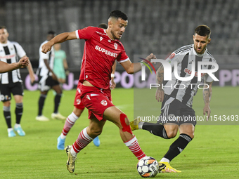 Astrit Selmani and Ovidiu Popescu are in action during Universitatea Cluj vs. Dinamo Bucuresti at Cluj Arena in Cluj-Napoca, Romania, on Sep...