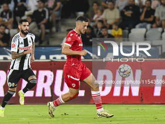 Astrit Selmani is in action during Universitatea Cluj vs. Dinamo Bucuresti at Cluj Arena in Cluj-Napoca, Romania, on September 2, 2024 (