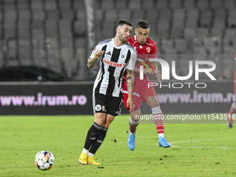 Catalin Cirjan and Ovidiu Popescu are in action during the Universitatea Cluj vs. Dinamo Bucuresti match at Cluj Arena in Cluj-Napoca, Roman...