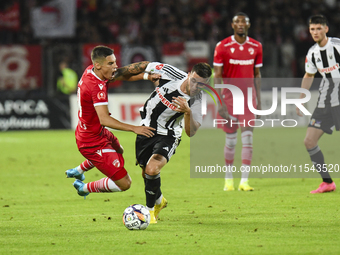 Catalin Cirjan and Ovidiu Popescu are in action during the Universitatea Cluj vs. Dinamo Bucuresti match at Cluj Arena in Cluj-Napoca, Roman...