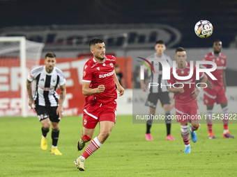 Astrit Selmani is in action during Universitatea Cluj vs. Dinamo Bucuresti at Cluj Arena in Cluj-Napoca, Romania, on September 2, 2024 (