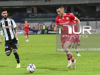 Astrit Selmani is in action during Universitatea Cluj vs. Dinamo Bucuresti at Cluj Arena in Cluj-Napoca, Romania, on September 2, 2024 (