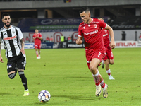 Astrit Selmani is in action during Universitatea Cluj vs. Dinamo Bucuresti at Cluj Arena in Cluj-Napoca, Romania, on September 2, 2024 (