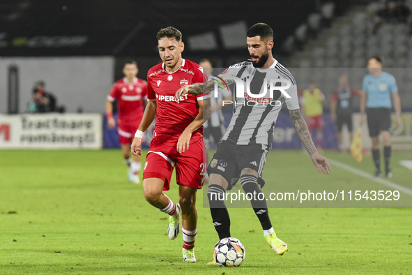 Radu Boboc and Ahmed Bani are in action during Universitatea Cluj vs. Dinamo Bucuresti at Cluj Arena in Cluj-Napoca, Romania, on September 2...