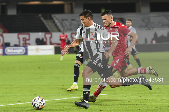 Astrit Selmani and Lucas Masoero are in action during Universitatea Cluj vs. Dinamo Bucuresti at Cluj Arena in Cluj-Napoca, Romania, on Sept...